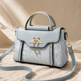 Velora – Swan-Clasp Structured Crossbody Bag with Gold Hardware
