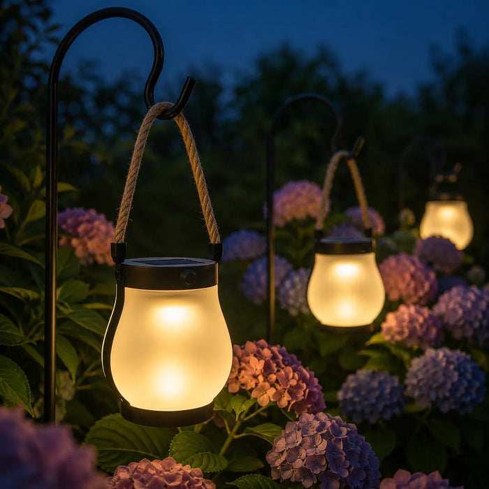 A group of Lumvera lanterns creating a warm garden glow
