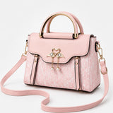 Velora – Swan-Clasp Structured Crossbody Bag with Gold Hardware