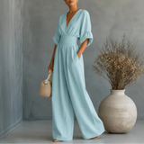 Soléra – Wide Leg V Neck Jumpsuit with Pleated Waist Sash